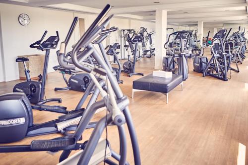 a gym with treadmills and elliptical machines at Hotel Nassauer Hof in Wiesbaden