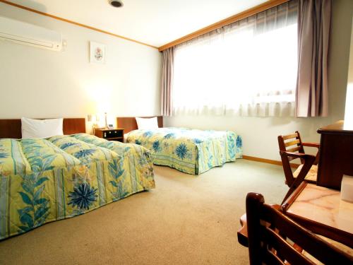 En eller flere senge i et værelse på Hotel Trend Saijo
