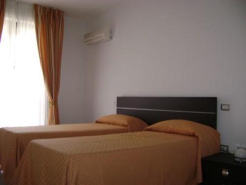 Ліжко або ліжка в номері Residence Montegrappa