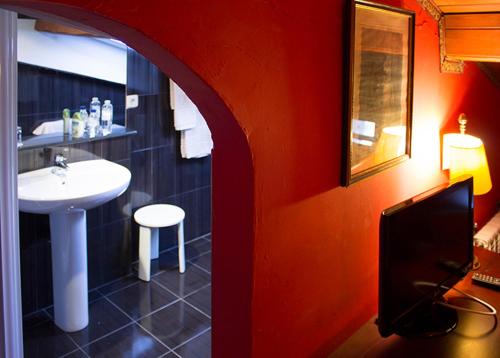 baño con lavabo y lavabo blanco en Hotel la Fundacion, en Bretún