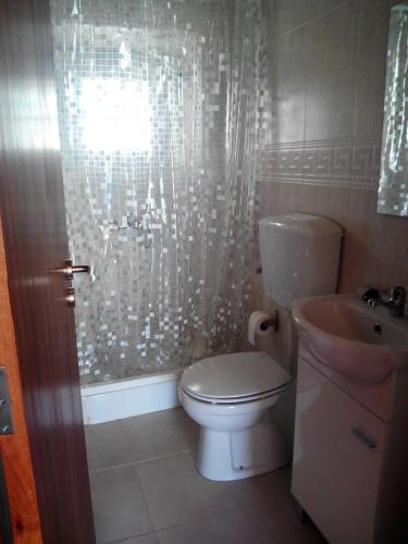 a bathroom with a toilet and a sink at Casa Do Avô In Montejunto in Cadaval