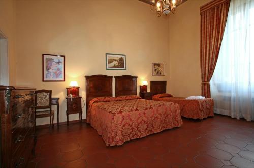 a hotel room with two beds and a window at Hotel Villa Liana in Florence
