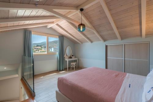 a bedroom with a bed and a large window at Pansion Ermioni in Skala
