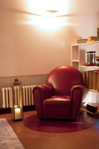 a red chair sitting on a rug in a room at Agriturismo La Casa Di Rodo in Quarrata