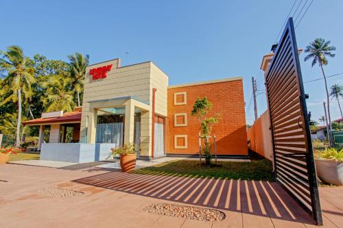 a building with a gate in front of it at Sevenday Hotel in Marawila