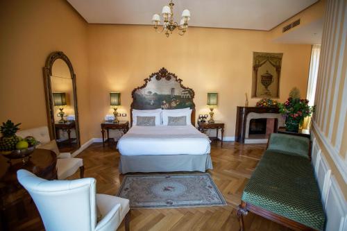a bedroom with a large bed and a fireplace at Royal Suite Trinità Dei Monti in Rome