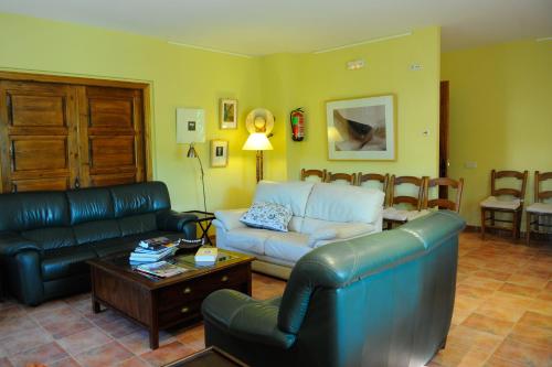 a living room with a couch and a table at Font del Pas in Beceite