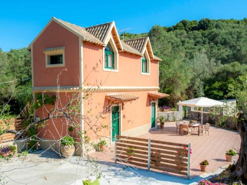 a house with a patio and a table at Pieros Studios Lisipios in Paleokastritsa