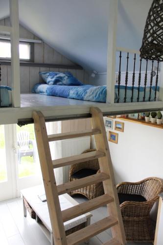 a loft bed in a room with a bunk bed at Bed and Stay Amsterdam in Amsterdam