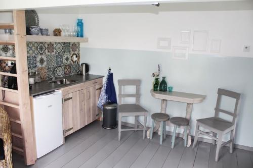 a kitchen with a table and chairs and a sink at Bed and Stay Amsterdam in Amsterdam
