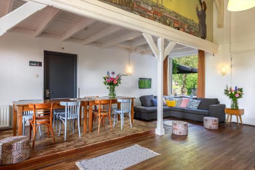 a kitchen and living room with a table and chairs at Stayokay Hostel Haarlem in Haarlem