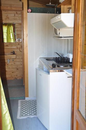 a kitchen with a stove and a counter top at Camping du Moulin de Thoard in Thoard