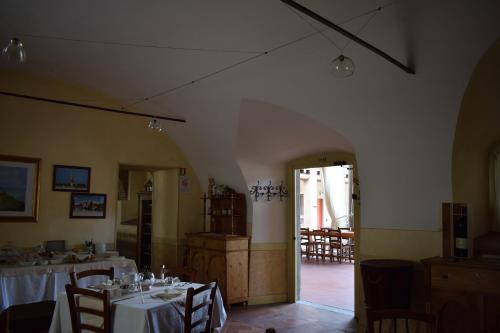 a dining room with tables and chairs in a room at Agriturismo Cà Del Lupo in Palazzolo sullʼOglio