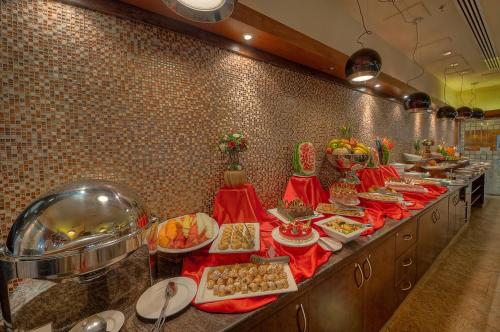 a buffet line in a restaurant with food on it at Sunday Marina View Hotel Apartments in Dubai