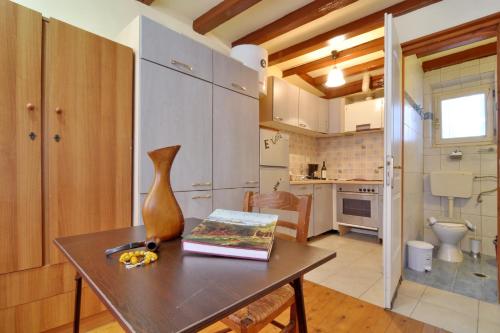 a kitchen with a table with a vase on it at Studio Milo in Corfu Town