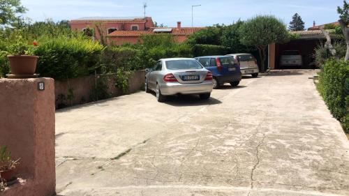 a group of cars parked in a parking lot at B&B Pani Silvio in Perfugas