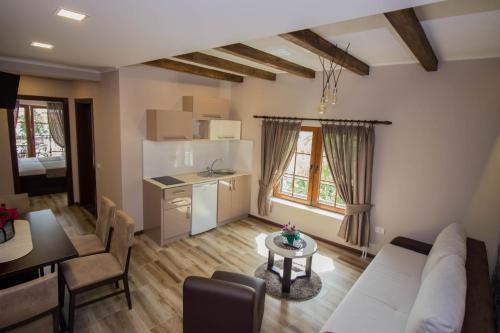 a living room with a white couch and a table at Apartments St Dimitrij in Ohrid