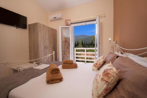 a bedroom with a bed with towels on it at Country Style Villa Christina in Pouláta