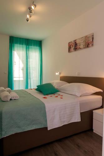 a bedroom with a large bed with towels on it at Apartments Silvia in Zadar