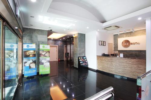 a lobby of a shopping center with a store at Noblesse Hotel in Jeju