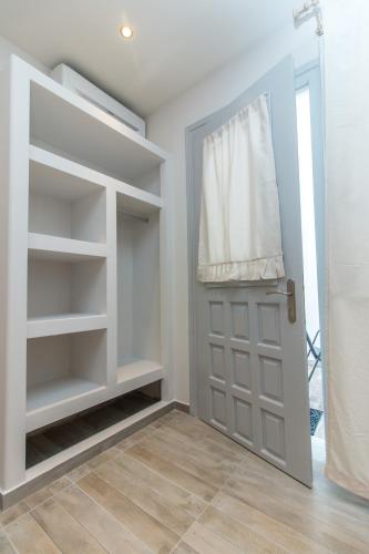 a walk in closet with a door and shelves at Relax Studios in Naxos Chora