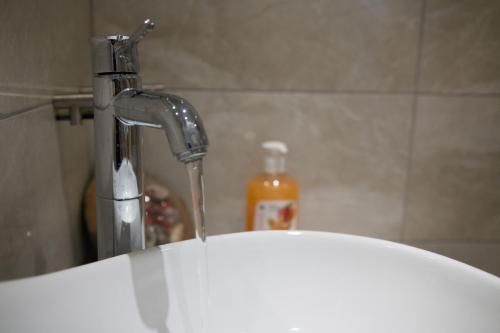 a bathroom sink with a running faucet at Relax Studios in Naxos Chora