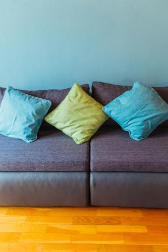 three pillows sitting on a couch in a room at Apartments Toni in Podstrana
