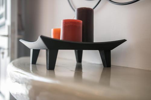 a black holder with two candles on a table at Relax Studios in Naxos Chora