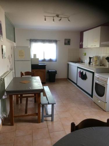 une cuisine avec une table et une salle à manger dans l'établissement Appartement / Gîte Les Papillons, à Lablachère