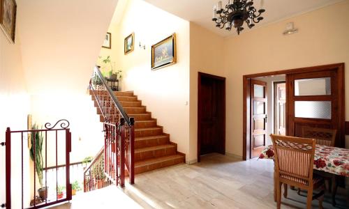 a hallway with a staircase in a house at Zespół Pałacowo-Parkowy Bądzów in Polkowice