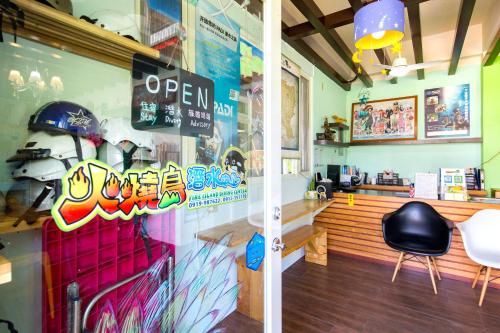 a restaurant with a window with a helmet on the wall at Fire Island Guest House in Green Island