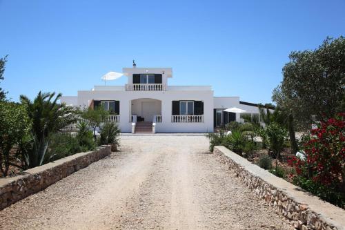 a white house on a dirt road at Villa Giulia&Gaia - Guest House in Nardò