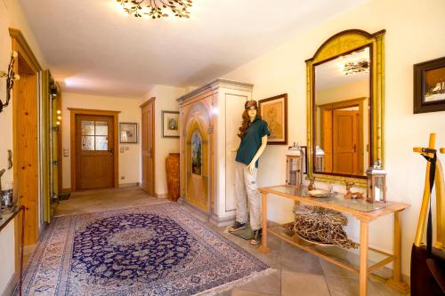 a woman standing in a room with a mirror at Bergkristall in Stummerberg