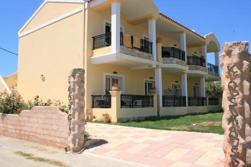 a villa with a view of the house at Kosmos Hotel in Agios Stefanos