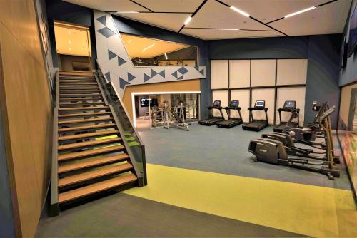 a gym with treadmills ellipticals and treadleys at The Fortyfive Business Hotel & Spa in Manisa