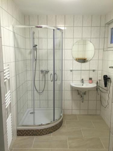 a bathroom with a shower and a sink at Privatzimmer Weber in Hautzenbichl