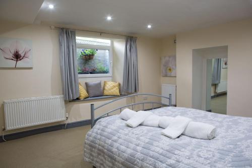 a bedroom with a bed with white pillows on it at The Old Inn at Plover Cottage Lindley in Huddersfield