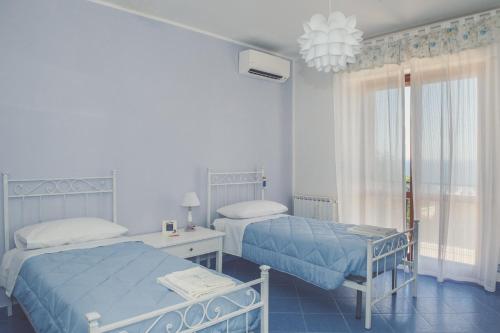 Ένα ή περισσότερα κρεβάτια σε δωμάτιο στο Il Giardino dei Lauri