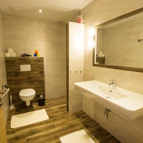 a bathroom with a sink and a toilet at Herzl Hof in Zellberg