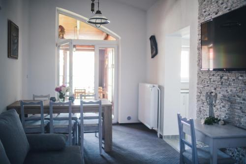 a dining room with a table and a refrigerator at Apartmany U Papoušků in Jindrichuv Hradec