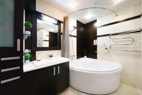 a bathroom with a white toilet and a sink at PaulMarie Apartments on Voinov Internatsionalistov in Vitebsk