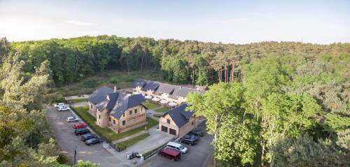 an aerial view of a large house with a parking lot at Pensjonat Leśniczówka in Słubice