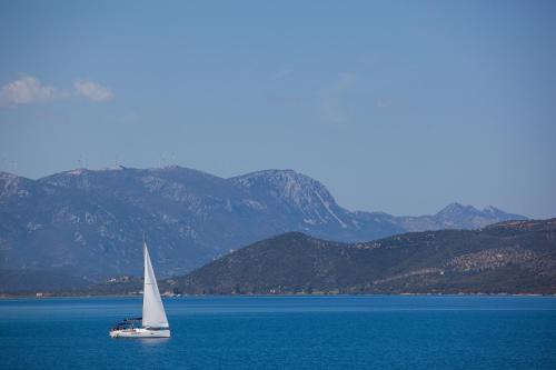 a sailboat in the middle of a large body of water at Hotel Saron in Poros