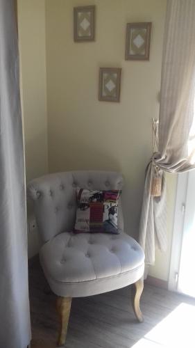 a white couch sitting in a room with a window at Du Coté de Lacoume in Anla
