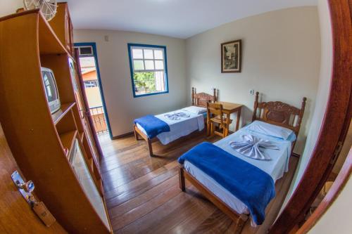 En eller flere senge i et værelse på Pousada Turismo