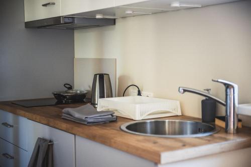 a kitchen counter top with a sink and a counter top at Krauklis beach apartments in Saulkrasti