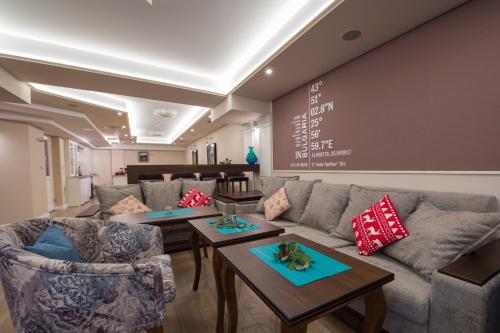 a living room with a couch and tables at Residence House Ruse in Ruse