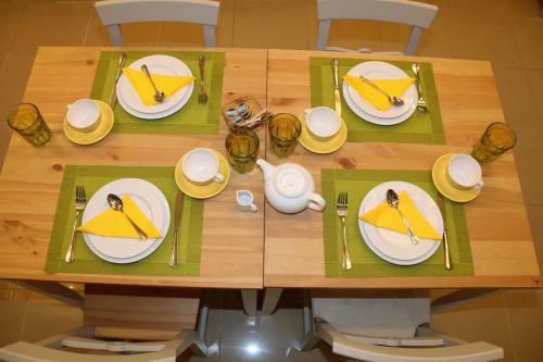 a table with plates and utensils on it at Aris Studios in Hersonissos