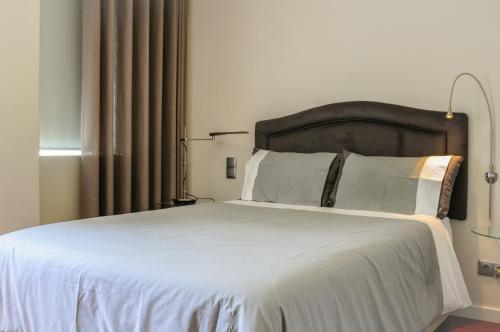 Кровать или кровати в номере Apartamento do Parque