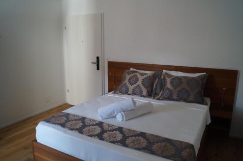 a bed with two white towels on it at Hotel Old Town in Zürich